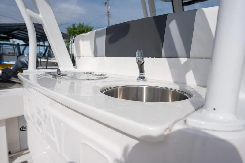 Slide: The Image of 2025 Robalo R270 Center Console boat interior with sink and seating. - 8