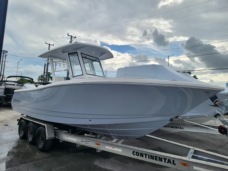 Slide: The Image of 2025 Robalo R270 Center Console boat on trailer under cloudy sky. - 9