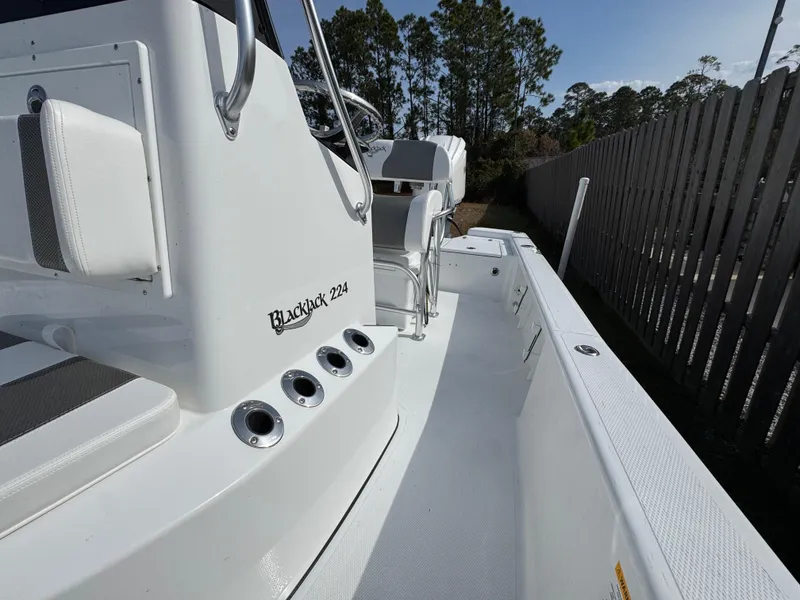 Slide: The Image of 2025 BlackJack 224 boat, white interior, sleek design, outdoor setting. - 10