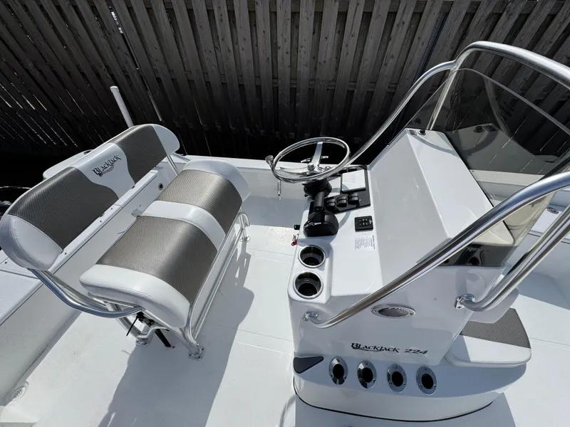 Slide: The Image of 2025 BlackJack 224 boat interior with steering console and seating. - 11