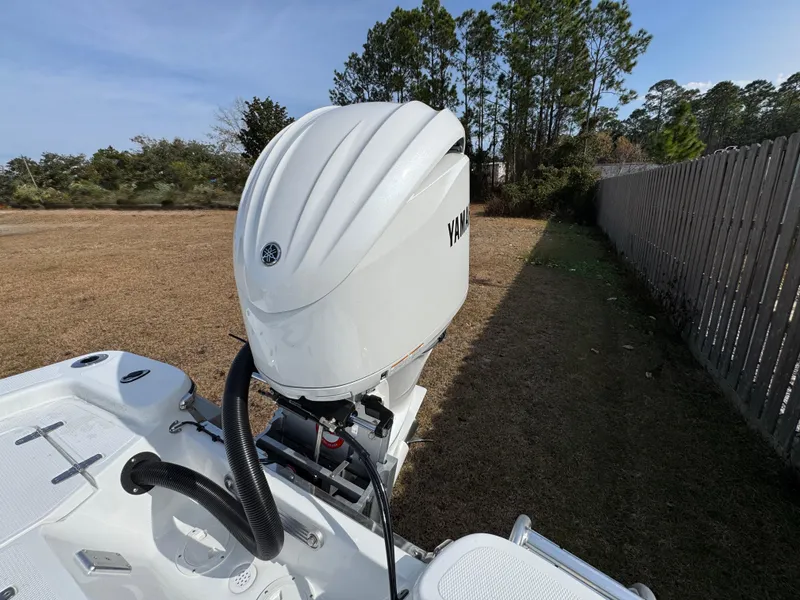 Slide: The Image of 2025 BlackJack 224 boat with Yamaha outboard motor in a grassy area. - 14