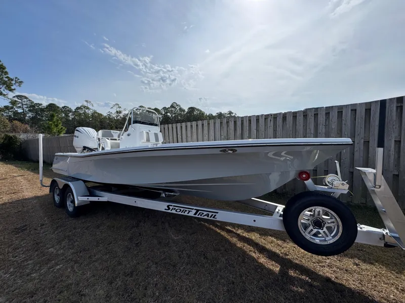 Slide: The Image of 2025 BlackJack 224 boat on Sport Trail trailer, parked outdoors. - 3