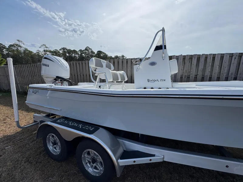 Slide: The Image of 2025 BlackJack 224 boat on trailer, featuring Yamaha outboard motor, parked outdoors. - 5