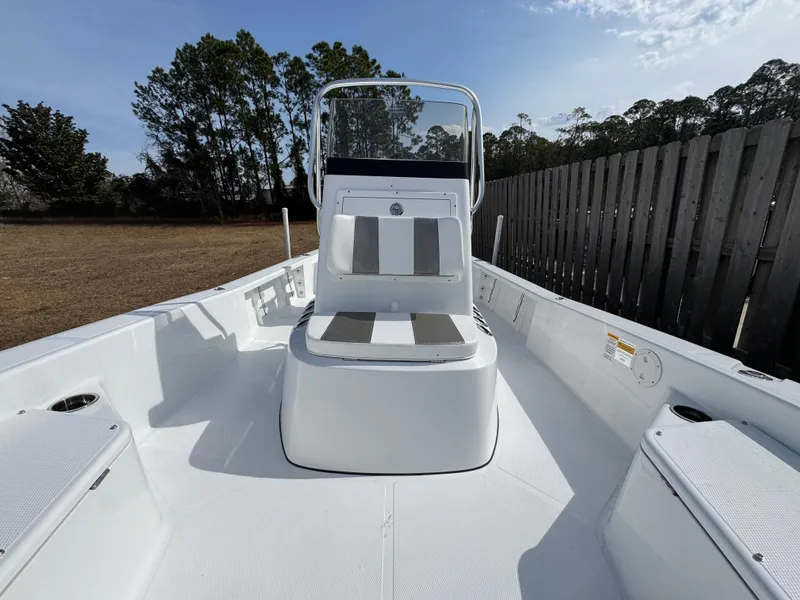 Slide: The Image of 2025 BlackJack 224 boat interior with seating, white deck, and console. - 8