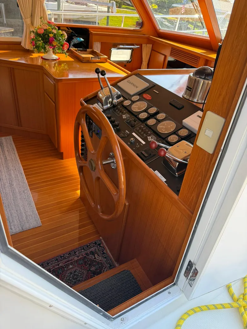 Slide: The Image of Interior of a 2002 Symbol 42' yacht with wooden helm and control panel. - 10