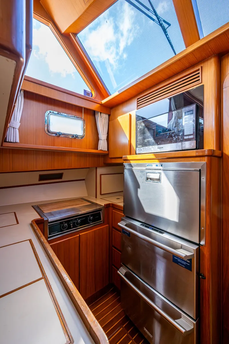 Slide: The Image of Luxurious kitchen interior of a 2002 Symbol 42' yacht with modern appliances and skylight. - 12