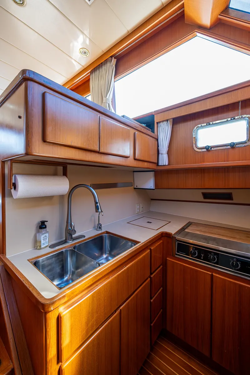 Slide: The Image of Luxurious 2002 Symbol 42' yacht kitchen with wood cabinetry and modern amenities. - 13