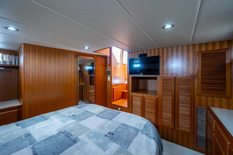 Slide: The Image of Luxurious cabin interior of a 2002 Symbol 42' yacht with wood paneling and modern amenities. - 15