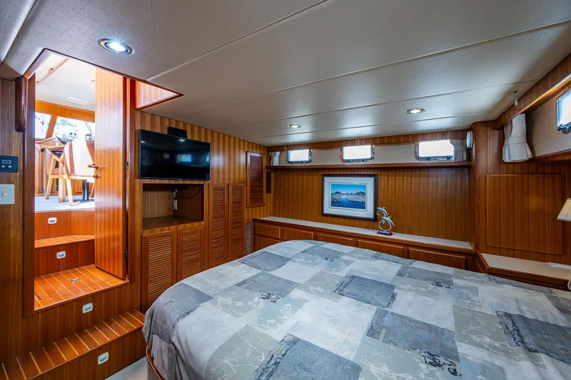 Slide: The Image of Luxurious cabin interior of a 2002 Symbol 42' yacht with wood paneling and modern amenities. - 16