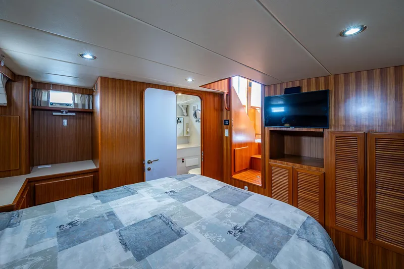 Slide: The Image of Luxurious 2002 Symbol 42' yacht interior with wood paneling, bed, and TV. - 17