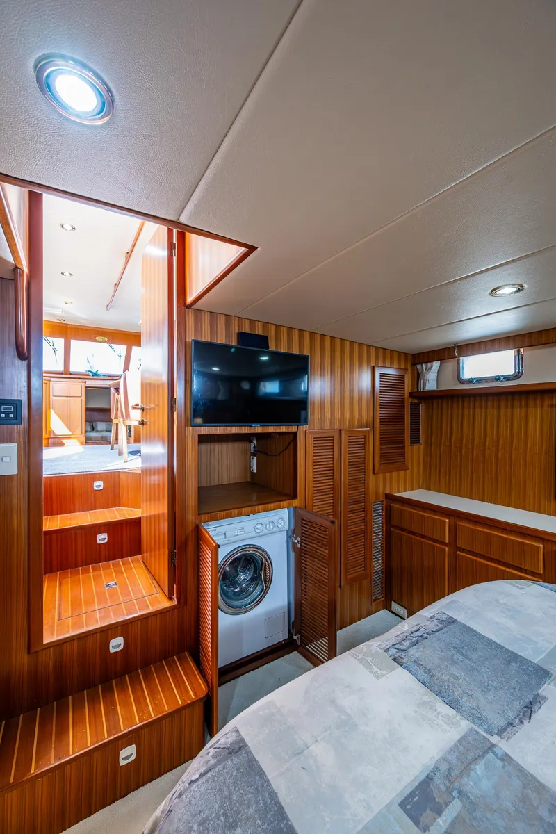 Slide: The Image of Luxurious interior of a 2002 Symbol 42' yacht with wood paneling and modern amenities. - 19