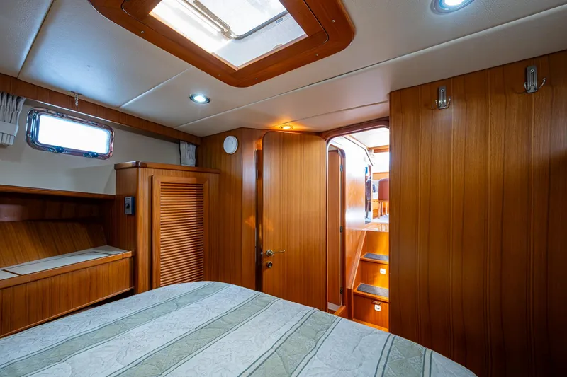 Slide: The Image of Cozy cabin interior of a 2002 Symbol 42' yacht with wooden paneling and skylight. - 24