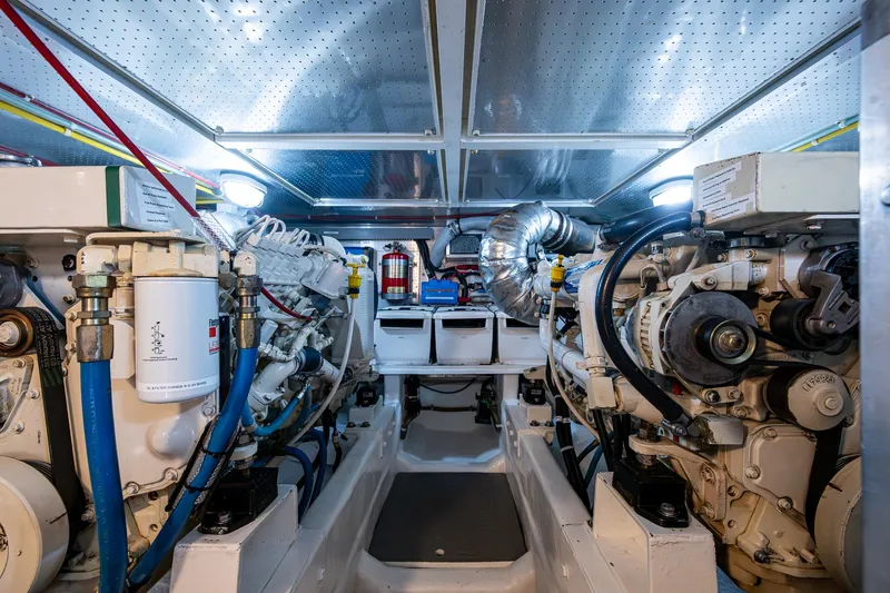Slide: The Image of Engine room of a 2002 Symbol 42' yacht, featuring dual engines and modern equipment. - 28