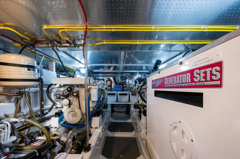 Slide: The Image of Engine room of a 2002 Symbol 42' yacht with generator sets and mechanical equipment. - 29