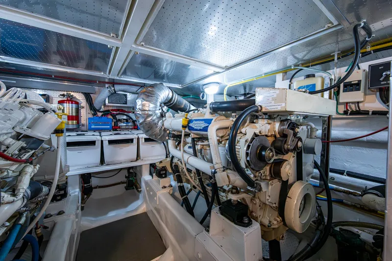 Slide: The Image of Engine room of a 2002 Symbol 42' yacht, featuring mechanical components and storage. - 32