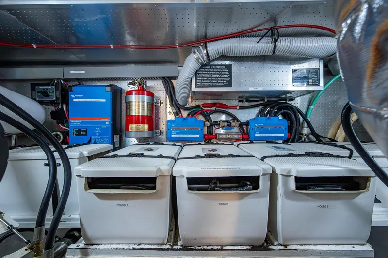 Slide: The Image of Engine room of a 2002 Symbol 42' yacht with batteries and fire extinguisher. - 33