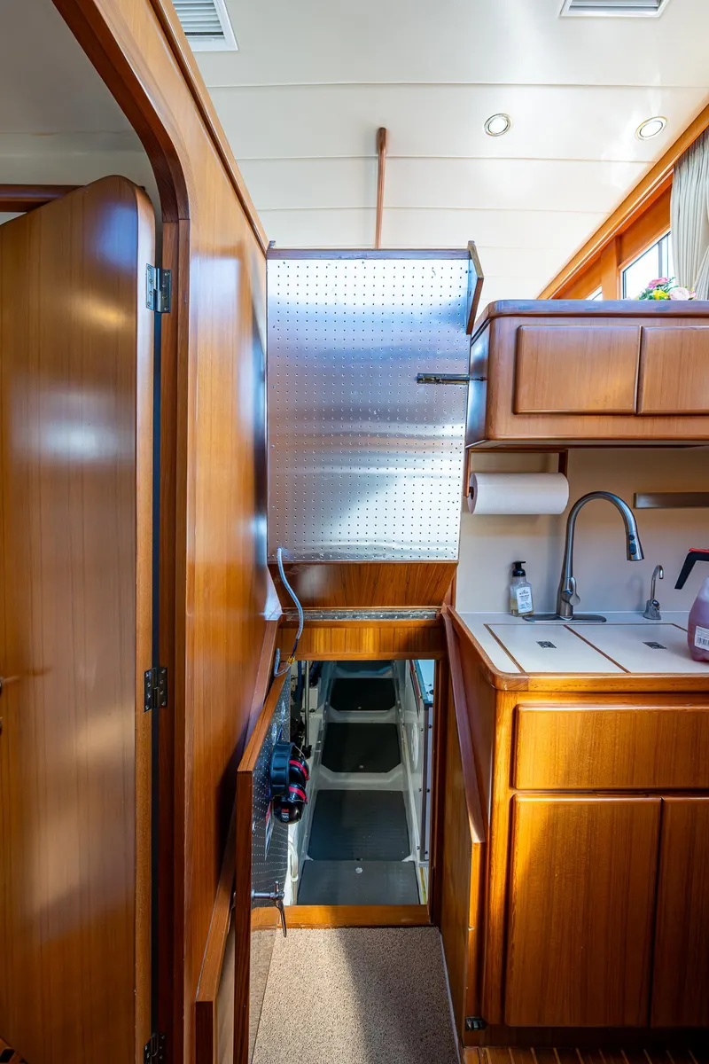 Slide: The Image of Interior of 2002 Symbol 42' yacht with wooden cabinetry and compact kitchen area. - 34