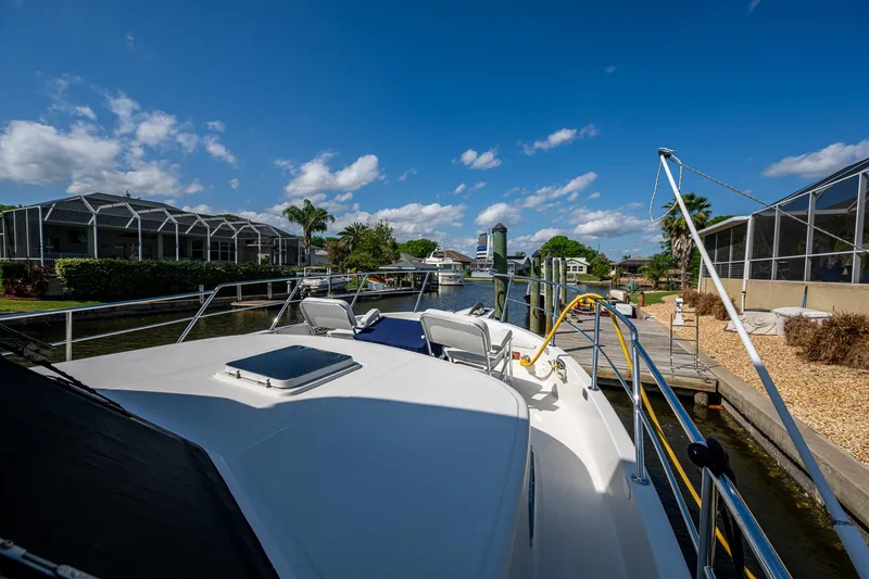 Slide: The Image of 2002 Symbol 42' yacht docked in sunny marina with clear blue skies. - 36