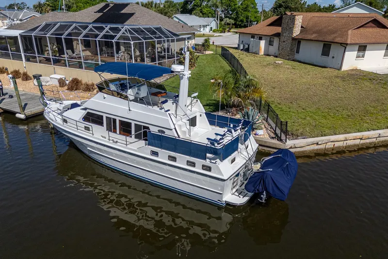 Slide: The Image of 42-foot Symbol yacht docked by waterfront homes, 2002 model. - 4