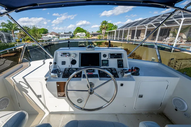 Slide: The Image of Helm of 2002 Symbol 42' yacht with steering wheel and navigation controls. - 40