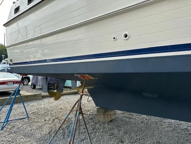 Slide: The Image of 2002 Symbol 42' yacht on stands, showing hull and propeller, in a boatyard. - 47