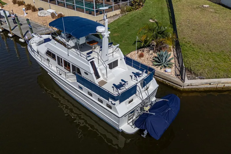 Slide: The Image of Aerial view of a 2002 Symbol 42' yacht docked by a landscaped shoreline. - 5