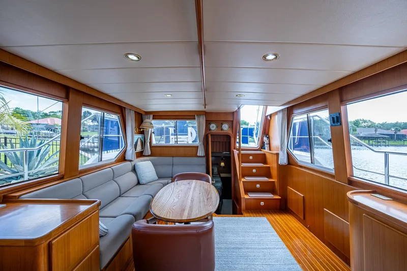 Slide: The Image of Luxurious interior of a 2002 Symbol 42' yacht with wood finishes and large windows. - 6