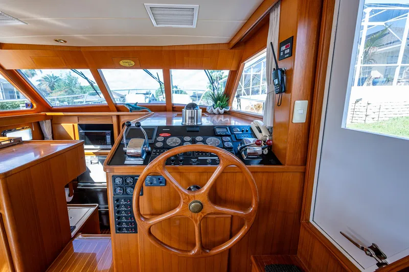 Slide: The Image of Helm of 2002 Symbol 42' yacht with wooden steering wheel and control panel. - 7