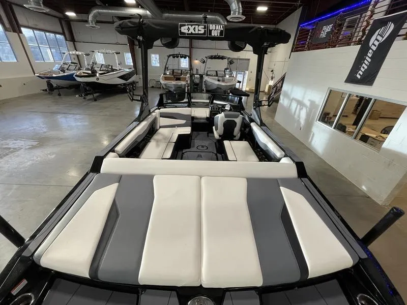 Slide: The Image of 2025 Axis T220 boat interior with sleek seating in a showroom. - 11