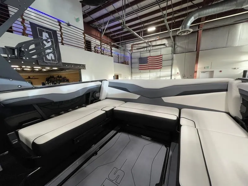 Slide: The Image of Interior of 2025 Axis T220 boat with modern seating in a showroom. - 16