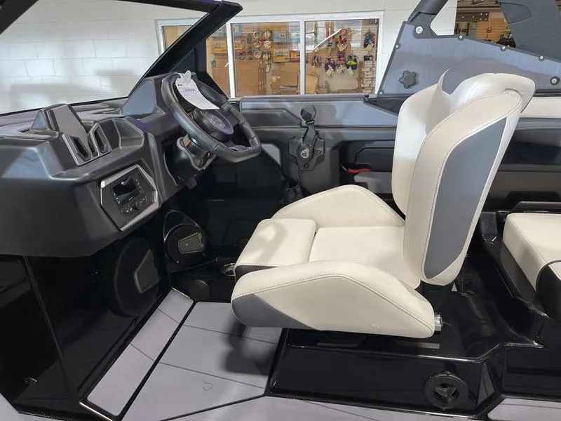 Slide: The Image of Interior of 2025 Axis T220 boat with modern dashboard and comfortable seating. - 17