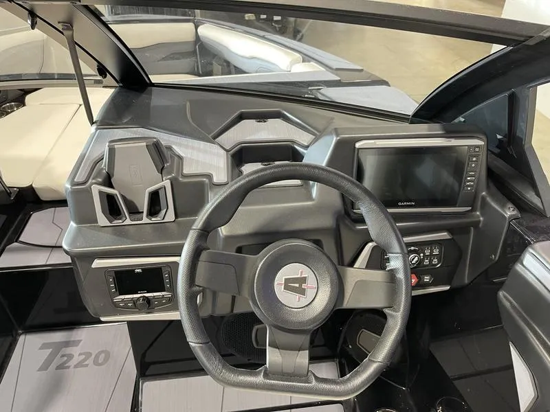 Slide: The Image of 2025 Axis T220 boat dashboard with steering wheel and touchscreen display. - 18