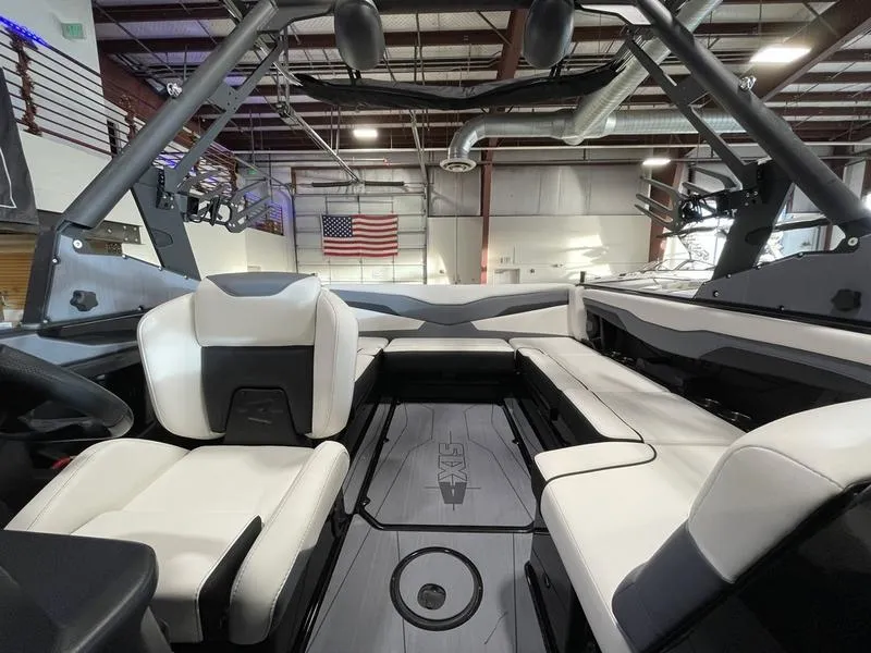 Slide: The Image of 2025 Axis T220 boat interior with white seating and American flag in the background. - 21