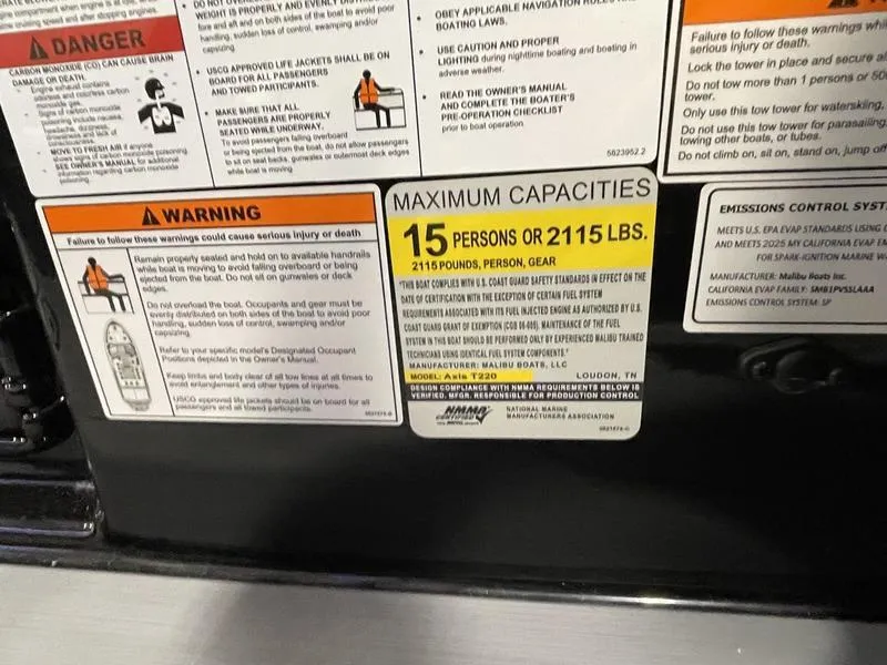 Slide: The Image of Warning and capacity labels on Axis T220, 2025 model, indicating 15 persons or 2115 lbs limit. - 22