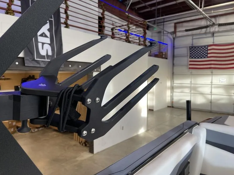 Slide: The Image of Axis T220 boat wakeboard rack in a modern garage with American flag. - 23