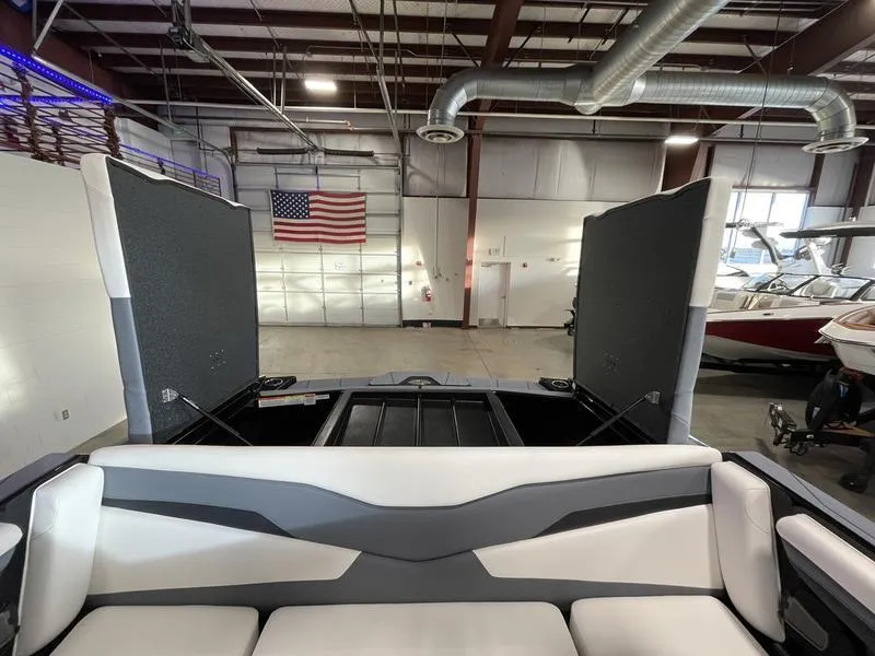 Slide: The Image of 2025 Axis T220 boat interior in a warehouse with American flag. - 25