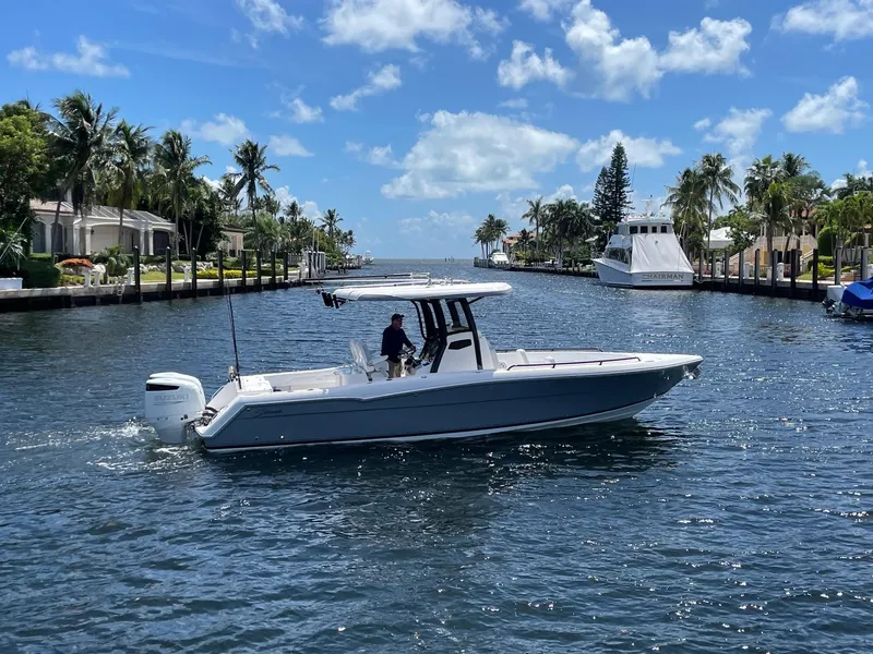 The Image of 2023 Stamas 31T Aventura boat cruising on a sunny canal with palm trees. - 0