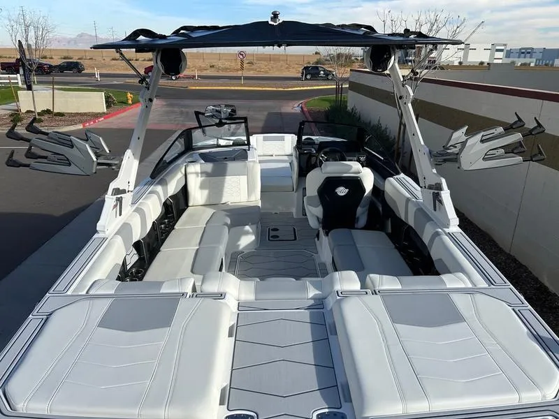 Slide: The Image of 2025 Malibu 23 MXZ boat interior with spacious seating and modern design. - 11