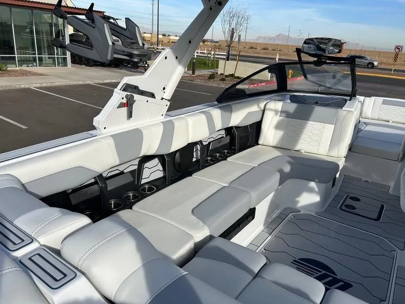 Slide: The Image of 2025 Malibu 23 MXZ boat interior with white seating and modern design. - 12