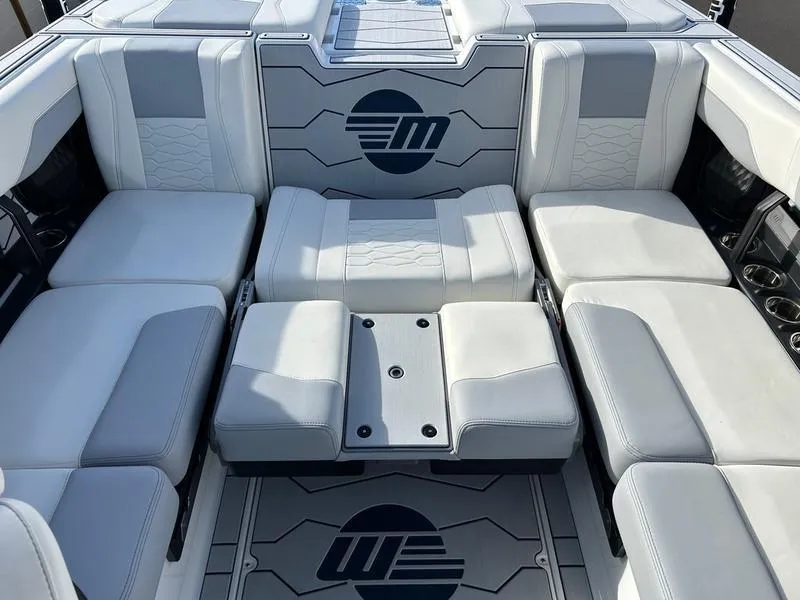 Slide: The Image of 2025 Malibu 23 MXZ boat interior with luxurious seating and modern design. - 19