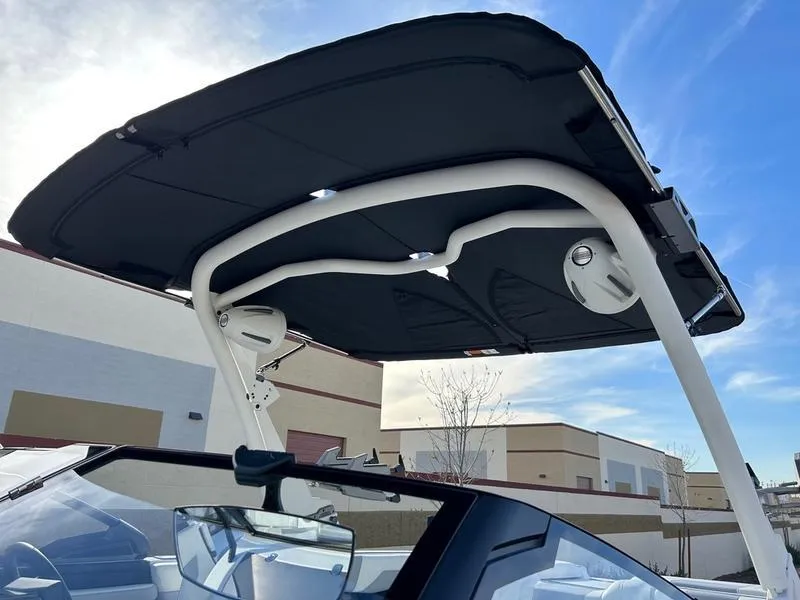 Slide: The Image of 2025 Malibu 23 MXZ boat with sleek black canopy and modern design. - 9