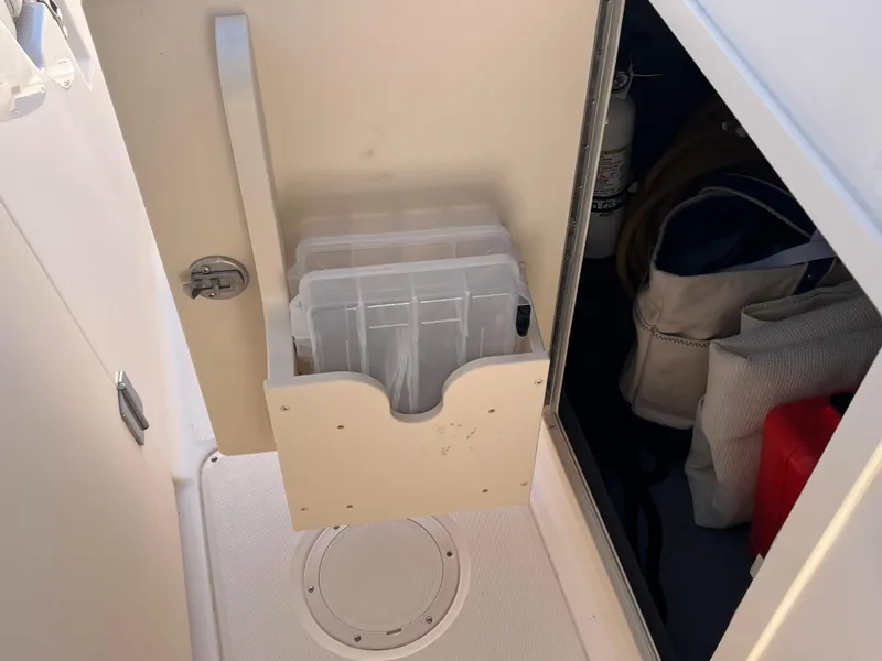 Slide: The Image of Storage compartment on a 2023 Grady-White Freedom 275 boat, featuring organized gear and equipment. - 16