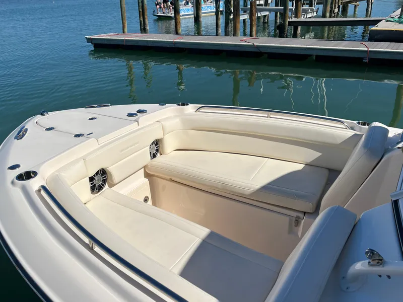 Slide: The Image of 2023 Grady-White Freedom 275 boat interior with seating at a marina dock. - 17