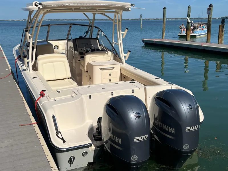 Slide: The Image of 2023 Grady-White Freedom 275 boat docked with twin Yamaha 200 engines. - 18