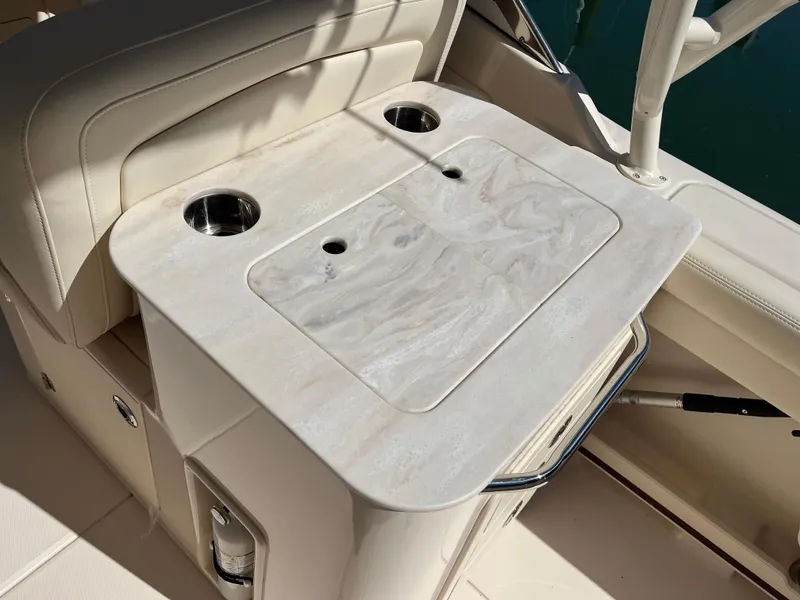 Slide: The Image of 2023 Grady-White Freedom 275 boat interior with a sleek countertop and cup holders. - 20