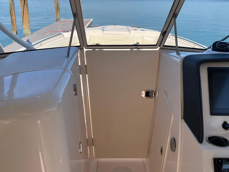 Slide: The Image of 2023 Grady-White Freedom 275 boat interior with dashboard and open water view. - 25