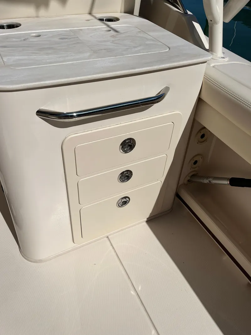 Slide: The Image of 2023 Grady-White Freedom 275 boat interior with storage drawers and countertop. - 27