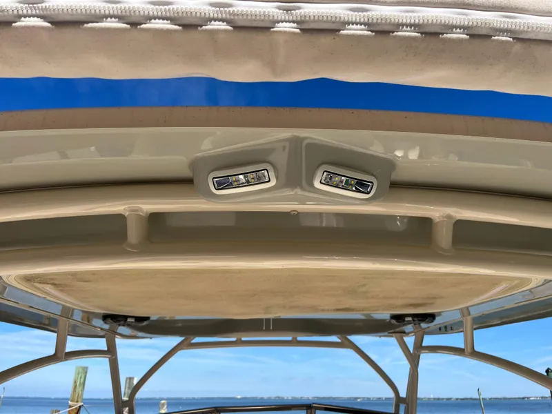 Slide: The Image of 2023 Grady-White Freedom 275 boat roof with integrated LED lights, clear sky background. - 3