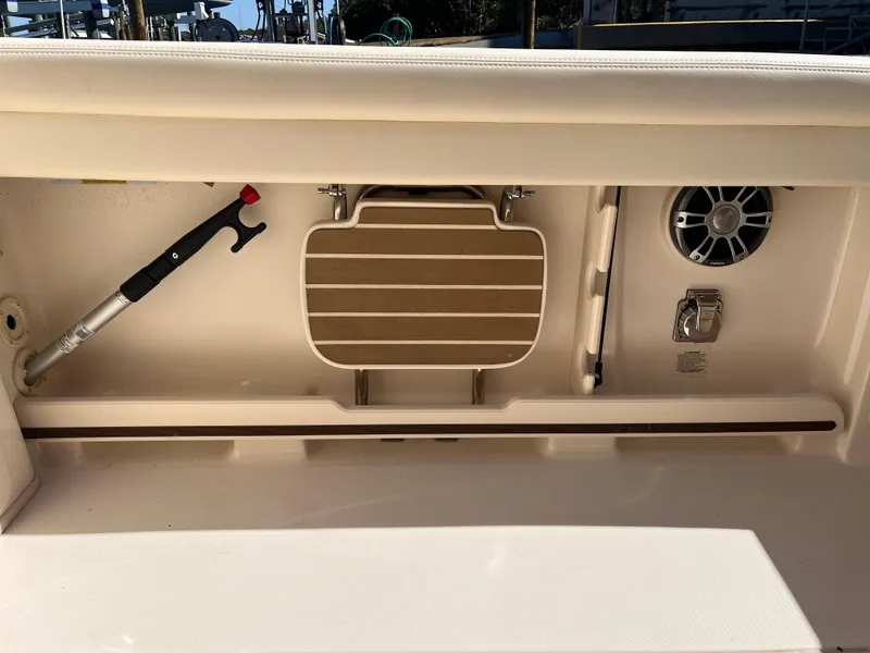 Slide: The Image of Storage compartment on 2023 Grady-White Freedom 275 boat with speaker and accessories. - 35