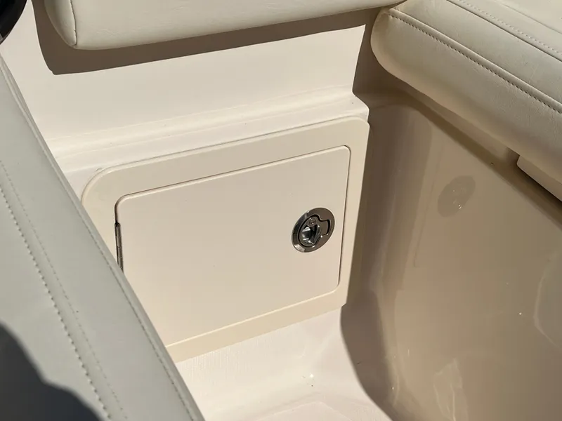 Slide: The Image of 2023 Grady-White Freedom 275 boat interior storage compartment with cushioned seating. - 37